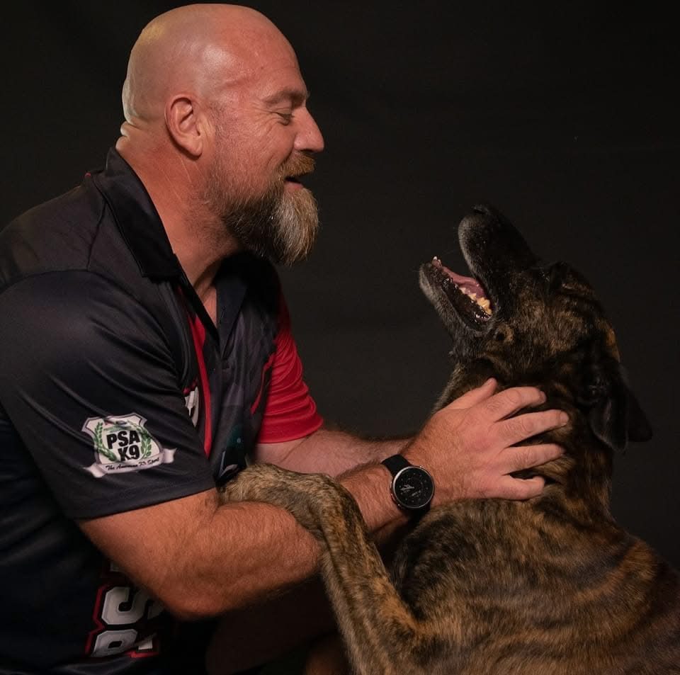 Charles sharing a happy moment with one of the dogs